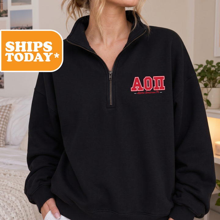 A person wearing a black sweatshirt with the letters "AOI" printed on it.