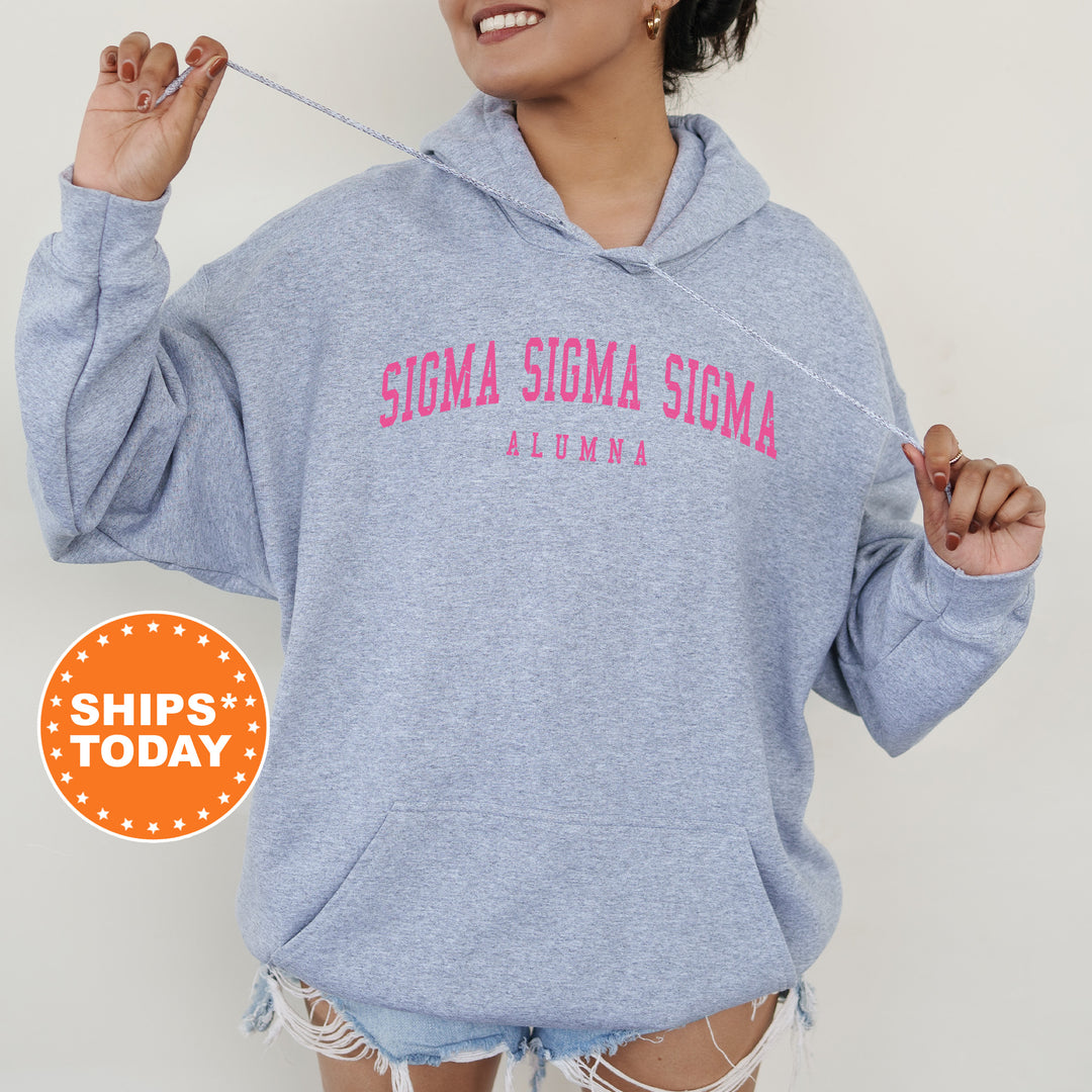 a woman wearing a blue sweatshirt with pink writing on it