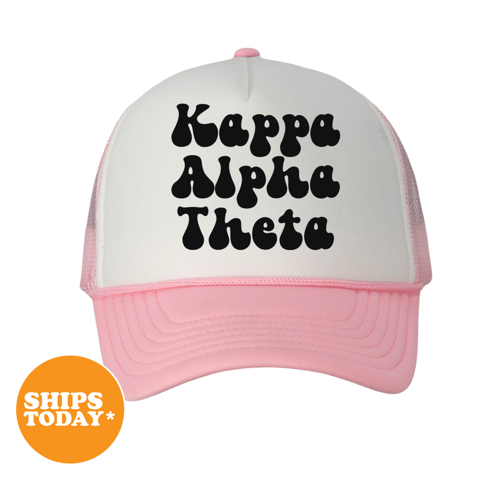 A pink and white baseball cap with the text " Kappa Alpha Theta" printed on it.