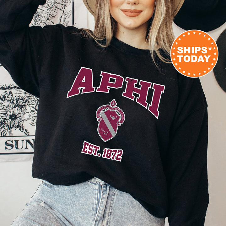 a woman wearing a black sweatshirt with the words aphi on it