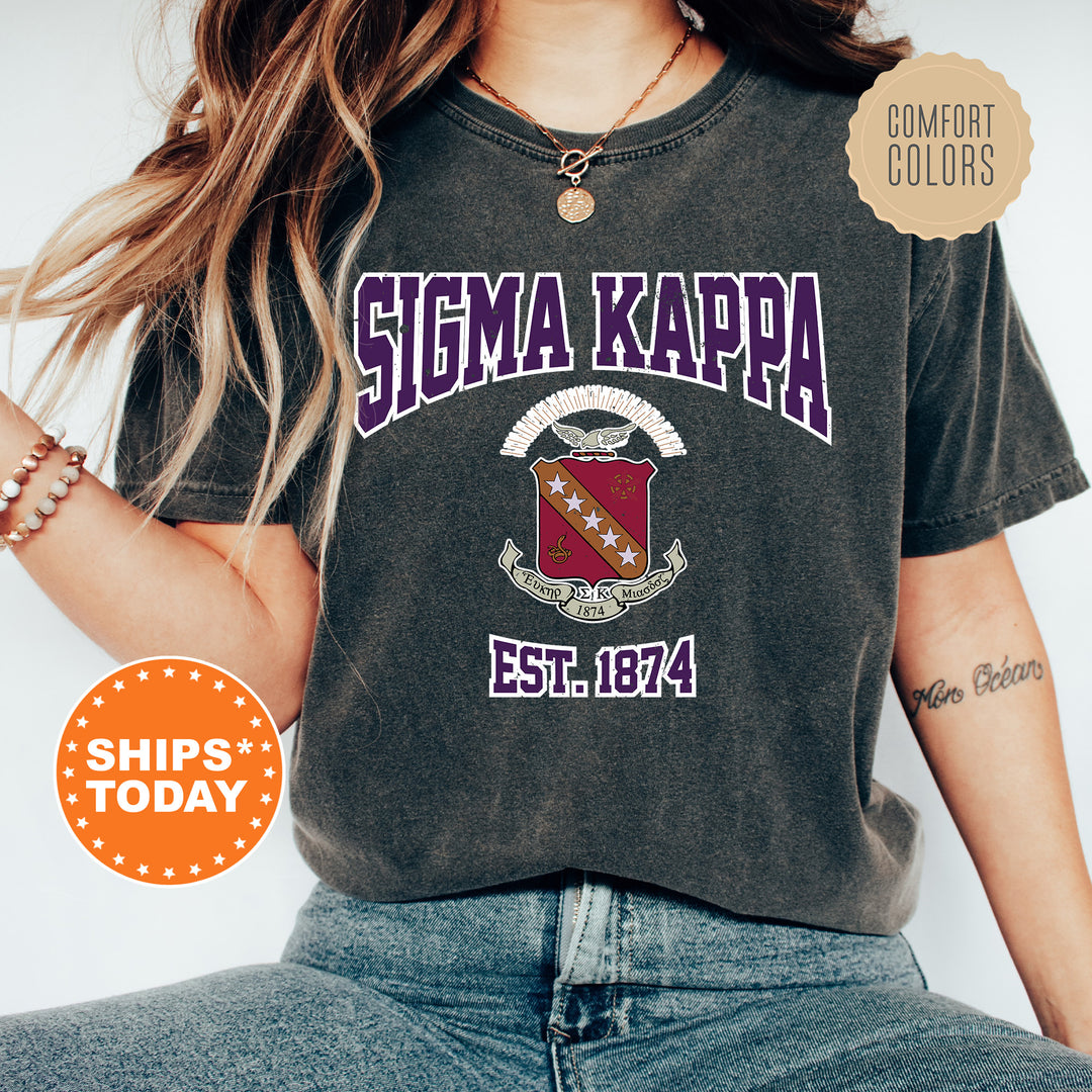 a woman wearing a tshirt with a crest on it