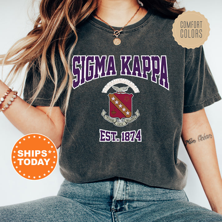a woman wearing a tshirt with a crest on it