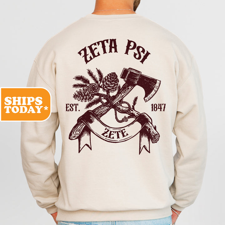 a man wearing a sweatshirt with an image of a hammer and pine cones on it
