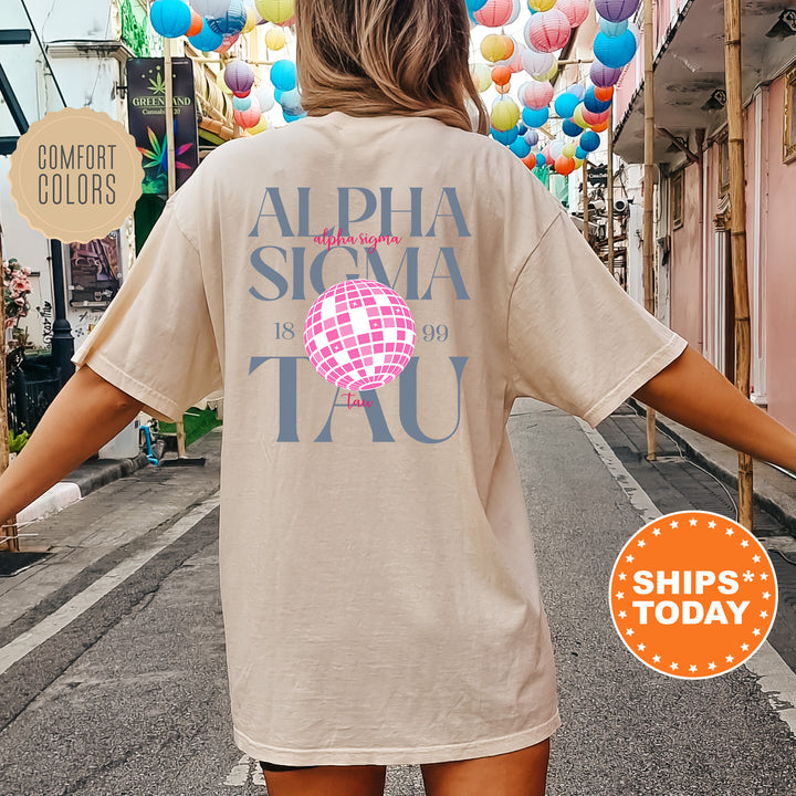a woman walking down a street with a t - shirt on