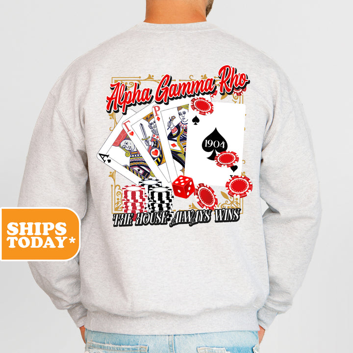 a man wearing a sweatshirt with a graphic of playing cards