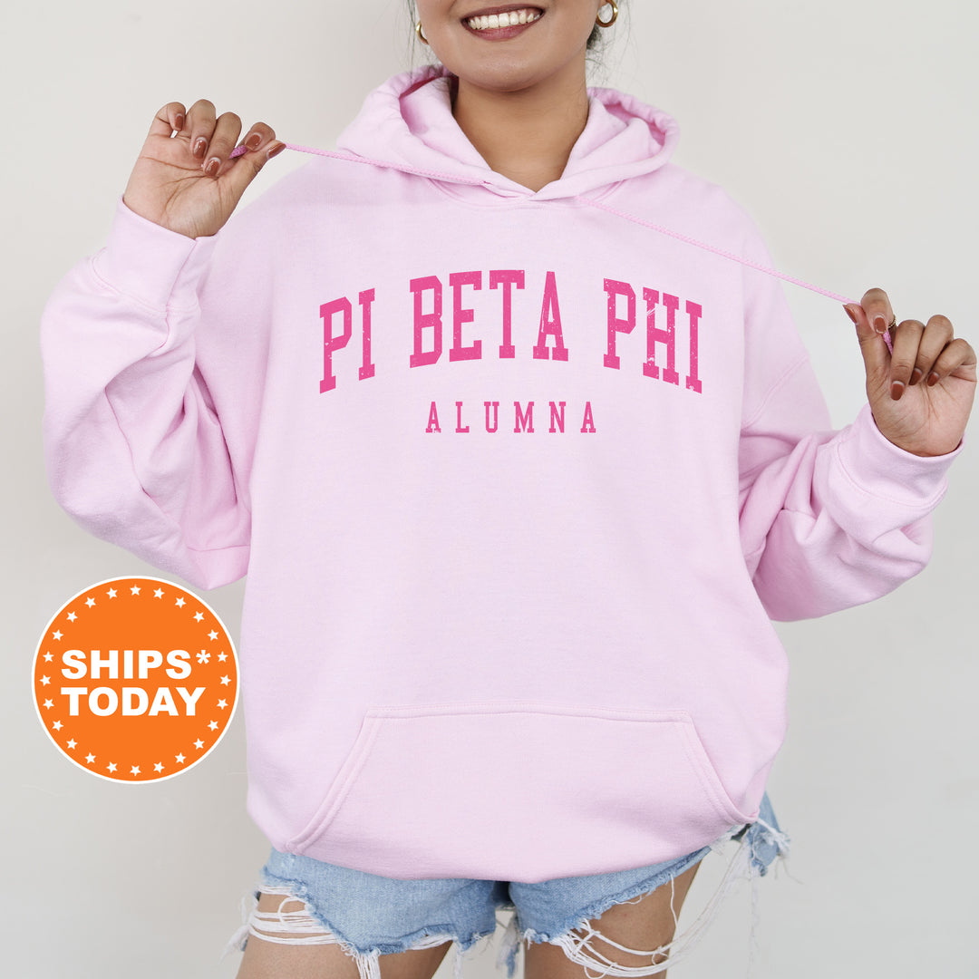 a woman wearing a pink hoodie and ripped shorts