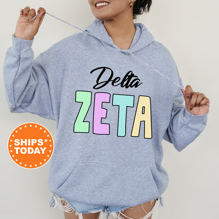 a woman wearing a delta sweatshirt with the word delta on it