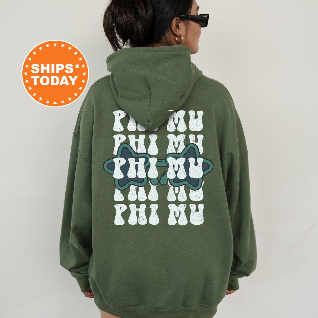 a woman wearing a green hoodie with the words phi phi phi on it