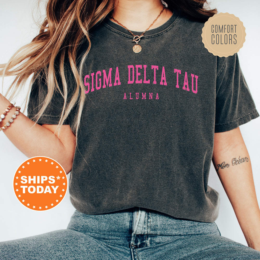 a woman wearing a shirt that says stigma delta tau