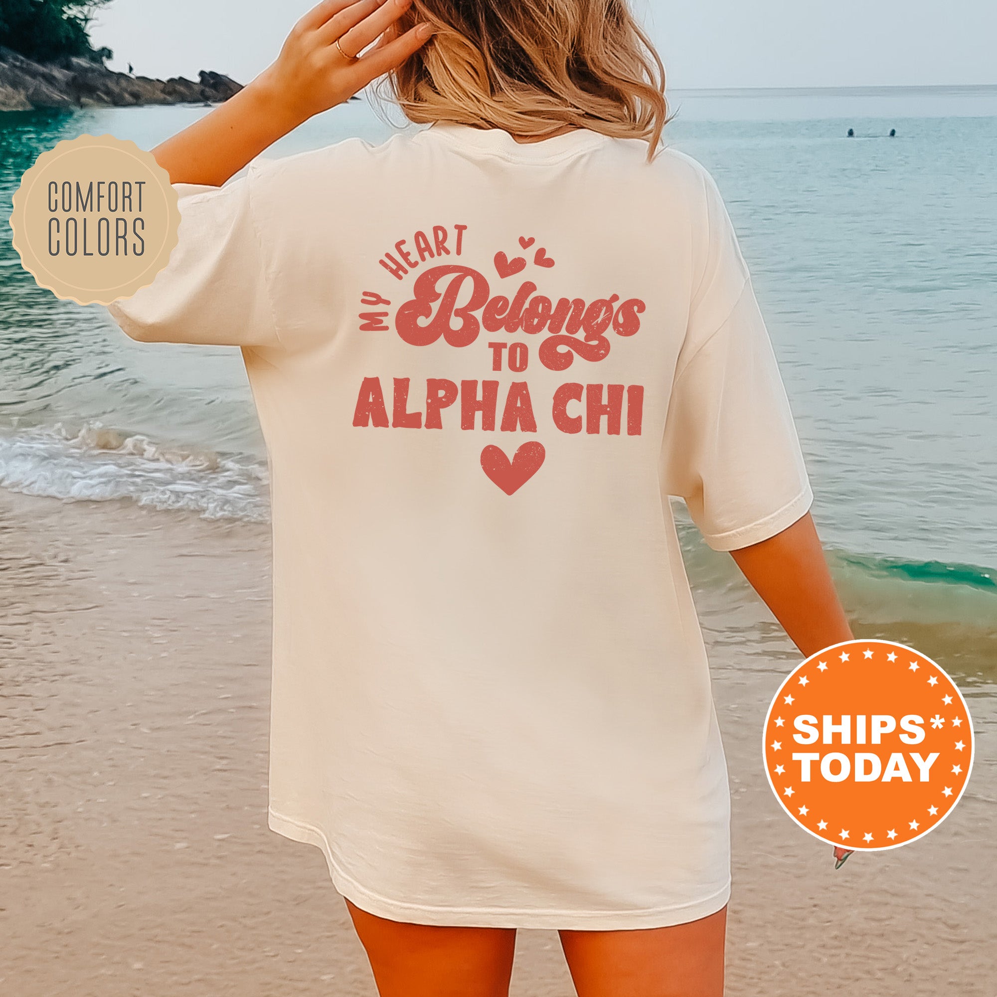 a woman standing on a beach wearing a white shirt