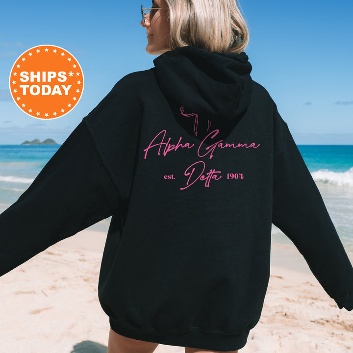 a woman in a black hoodie on the beach