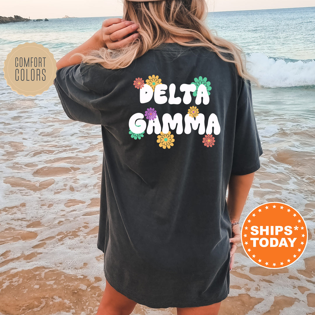 a woman standing on a beach wearing a black shirt