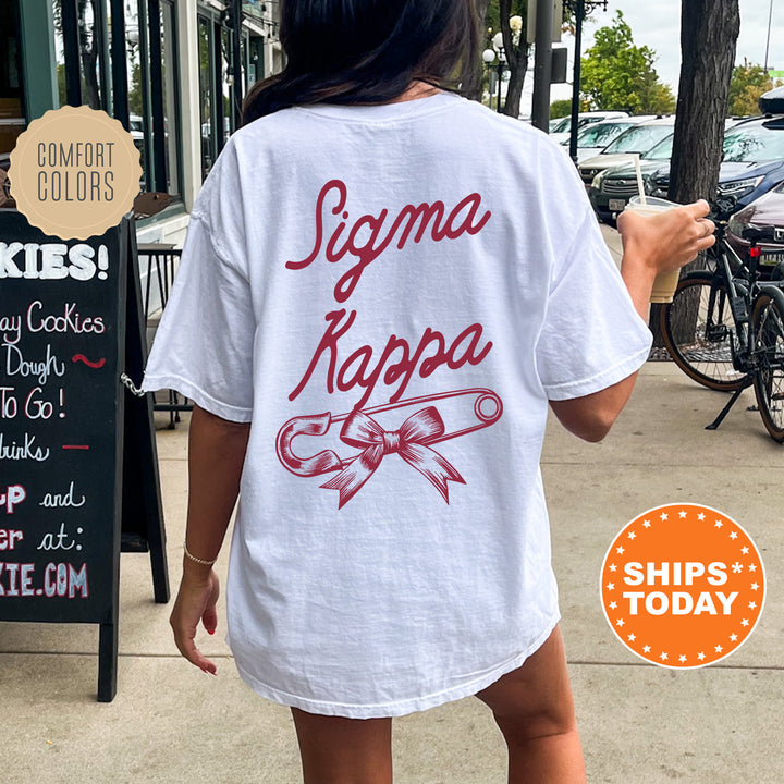 a woman walking down a sidewalk while wearing a white shirt