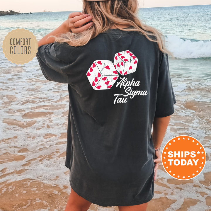 a woman standing on a beach wearing a black shirt