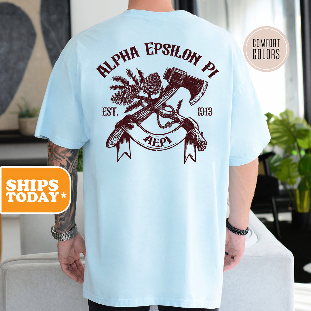 a man wearing a blue shirt with an image of a hammer and a pine tree