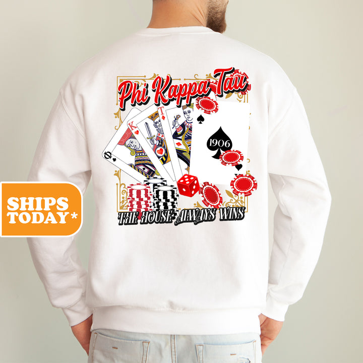 a man wearing a white sweatshirt with a picture of playing cards on it