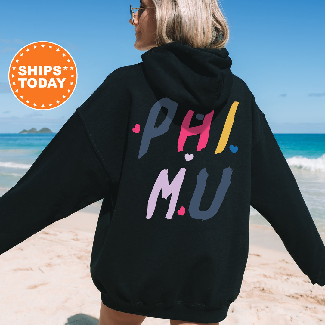 a woman in a black hoodie on the beach