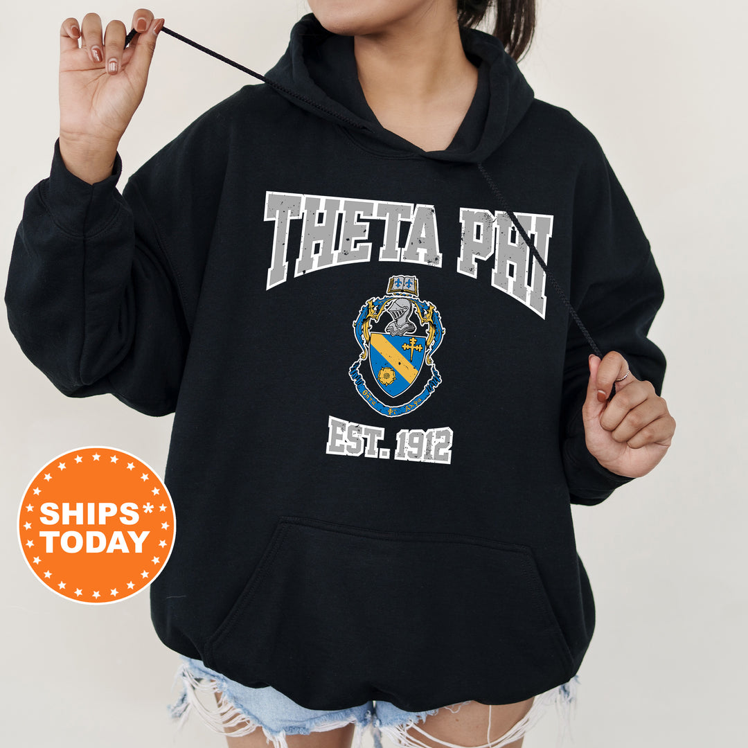 a woman in a black hoodie holding a toothbrush