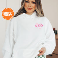 a woman wearing a white hoodie with the word axo printed on it