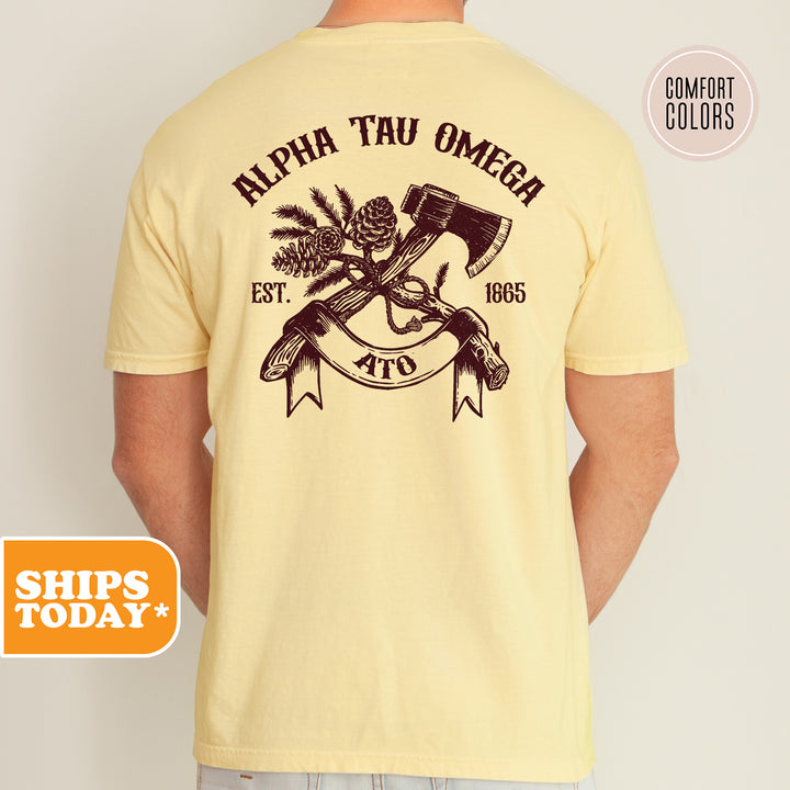 a man wearing a yellow t - shirt with an image of two crossed axes and