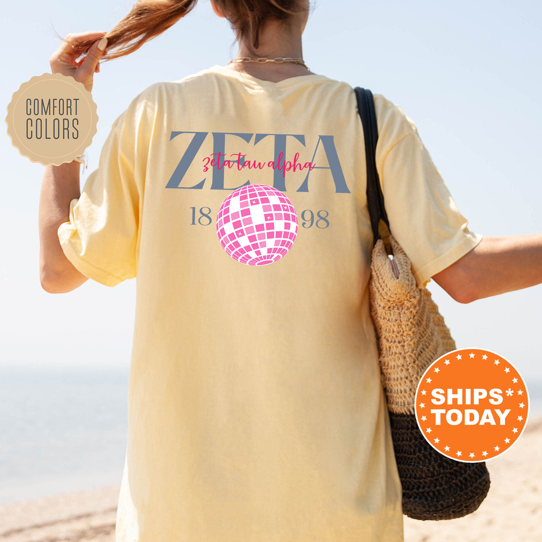a woman walking on the beach with a t - shirt on