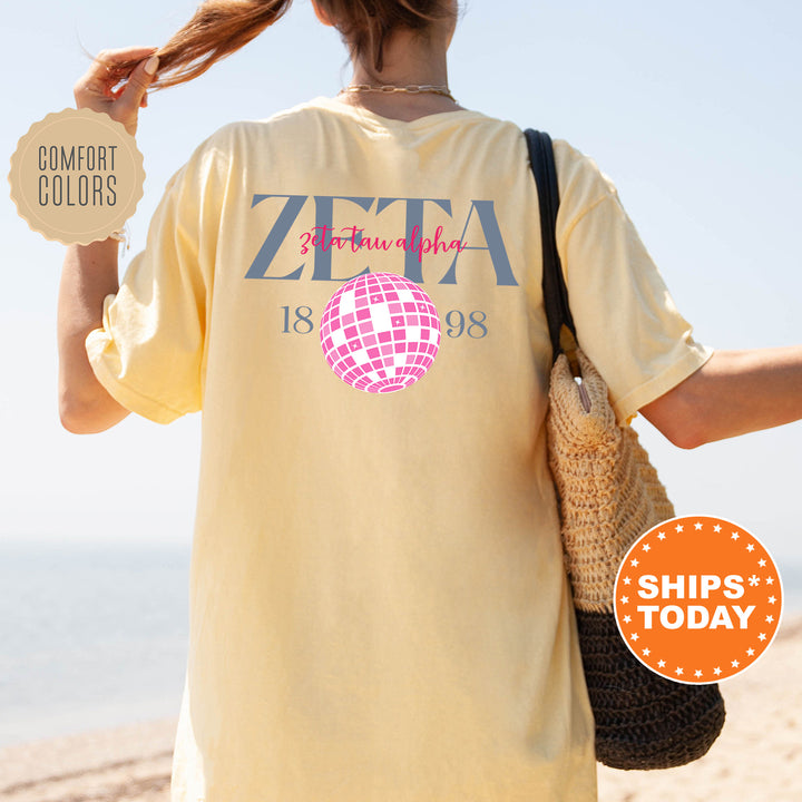 a woman walking on the beach with a t - shirt on