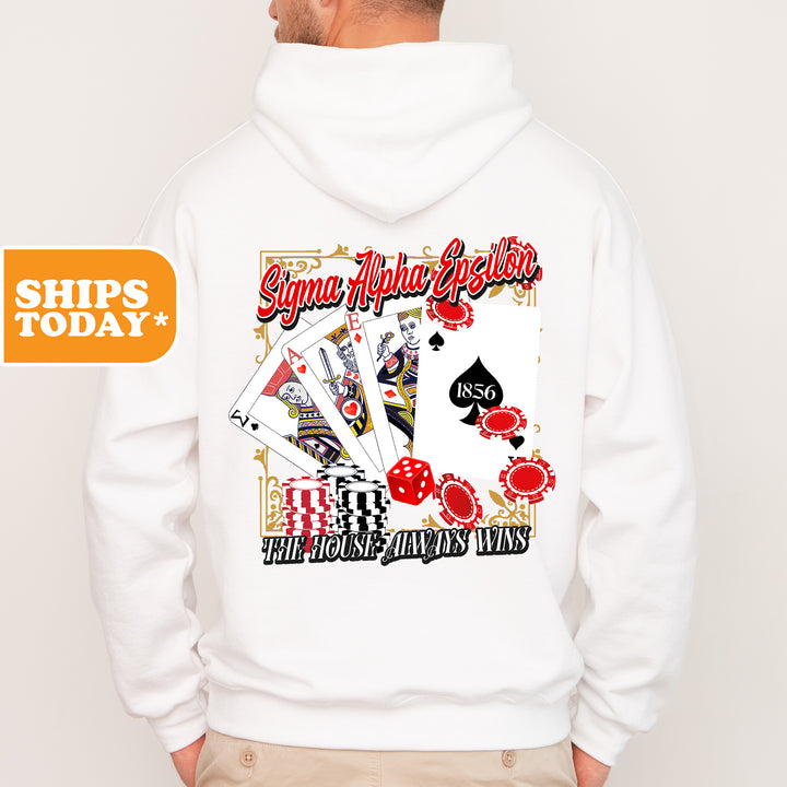 a man wearing a white hoodie with a picture of playing cards on it