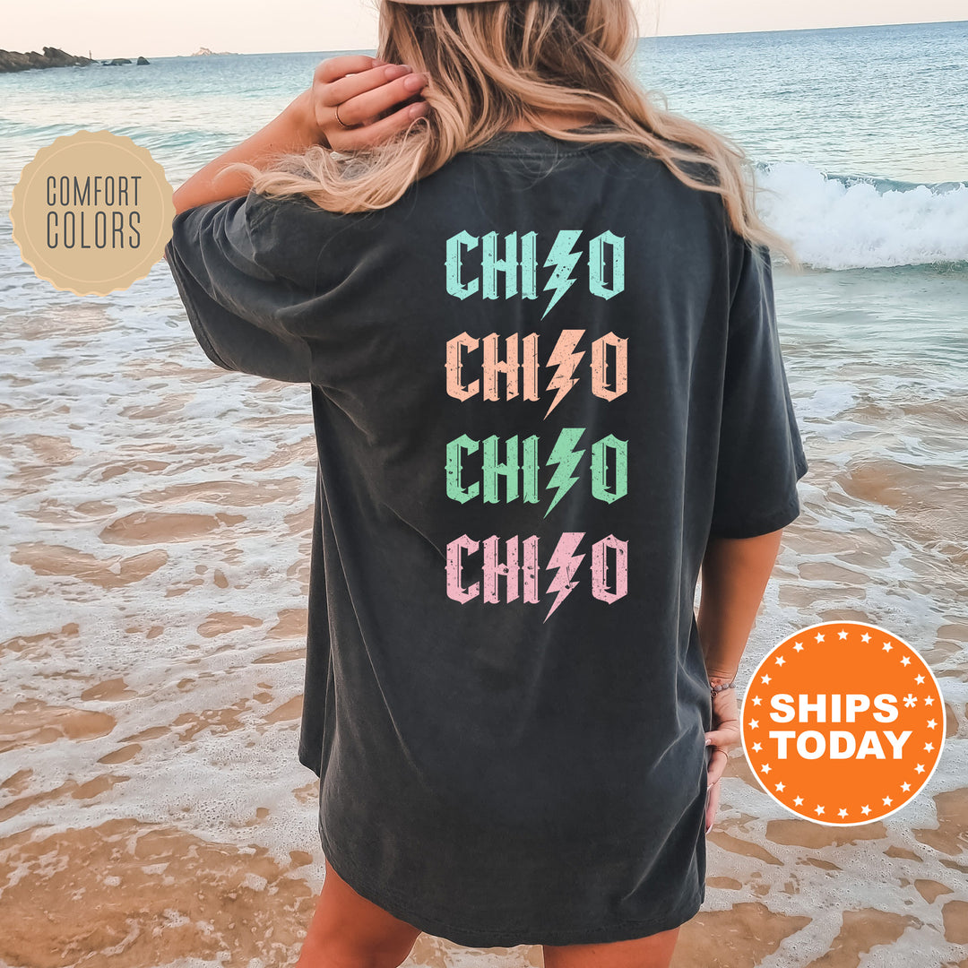 a woman standing on a beach wearing a black shirt