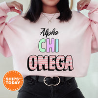 a woman wearing a pink sweatshirt with the words aloha chi omega on it