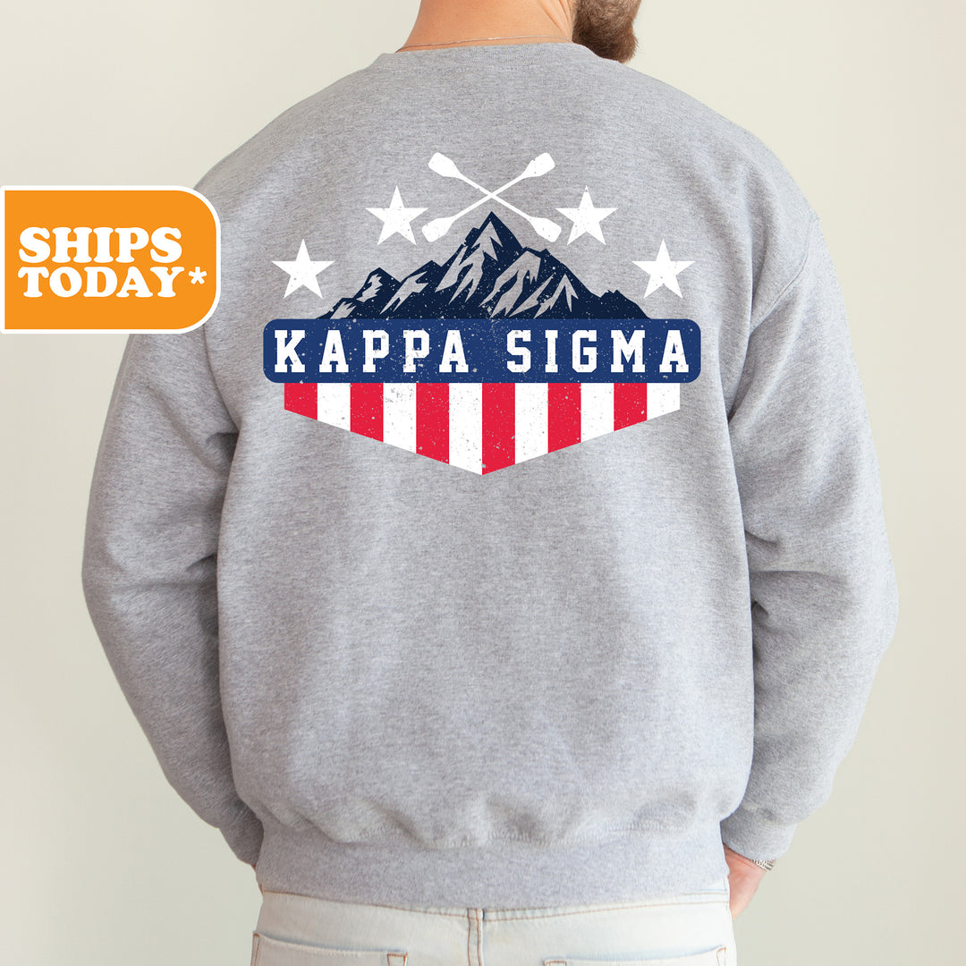 a man wearing a gray sweatshirt with the words kapa stigma on it