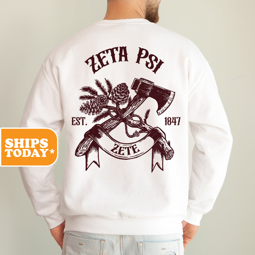 a man wearing a white sweatshirt with an image of a hammer and a pine tree