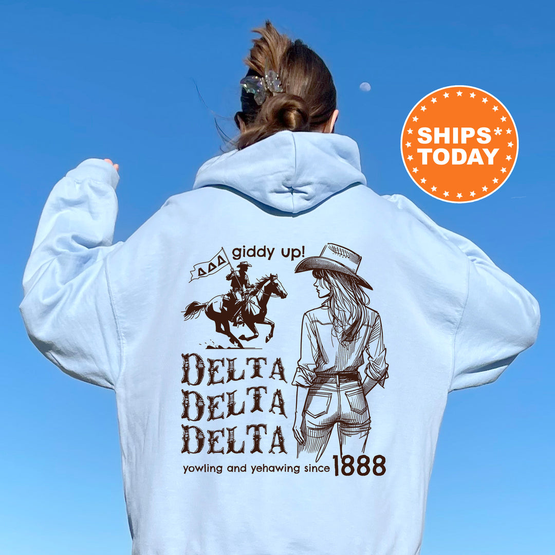 a woman wearing a white hoodie with a picture of a woman riding a horse