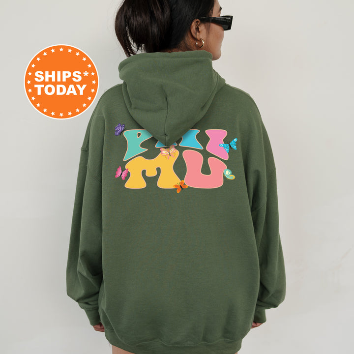 a woman wearing a green hoodie with a colorful dog on it