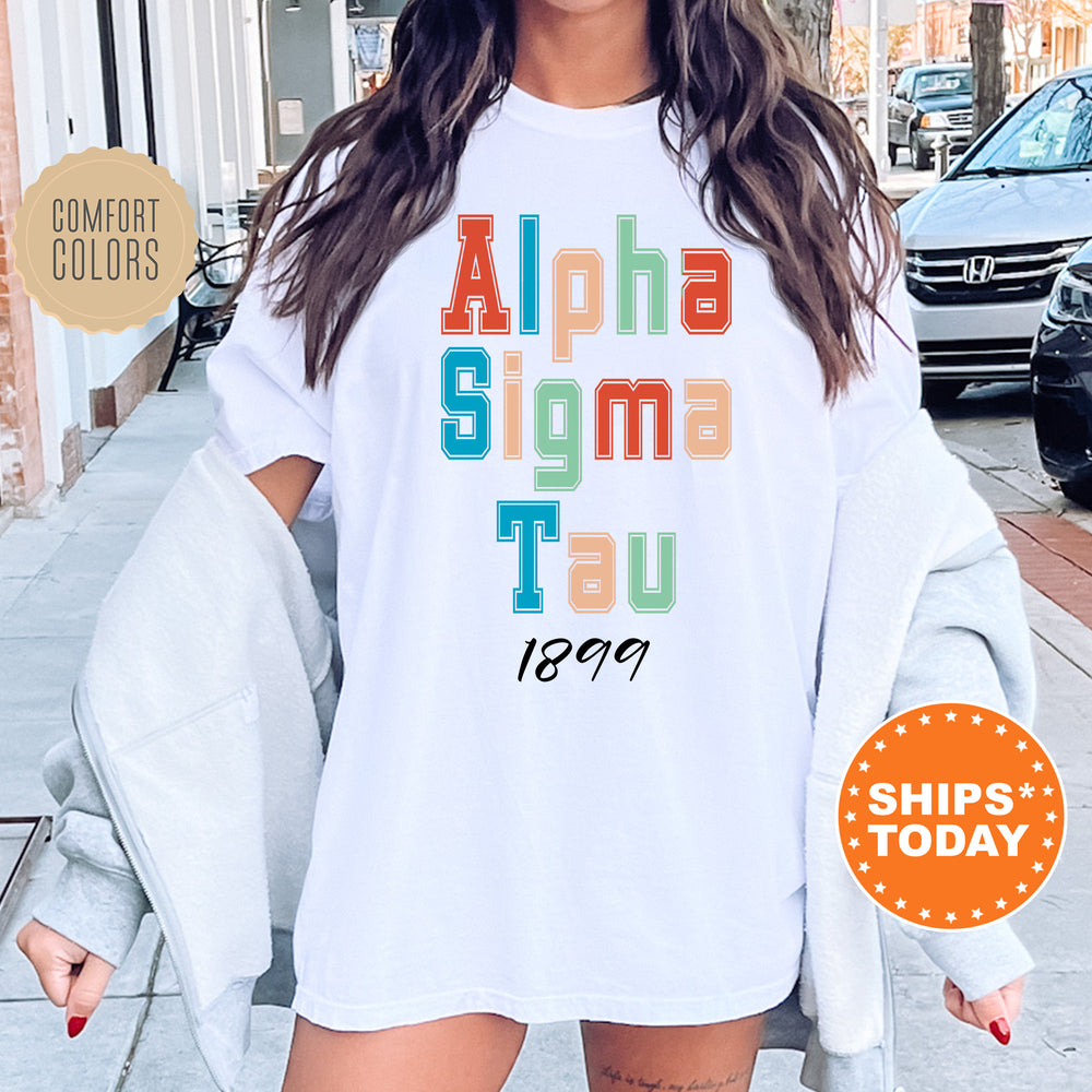 a woman wearing a white shirt with the words aloha sigmma tau