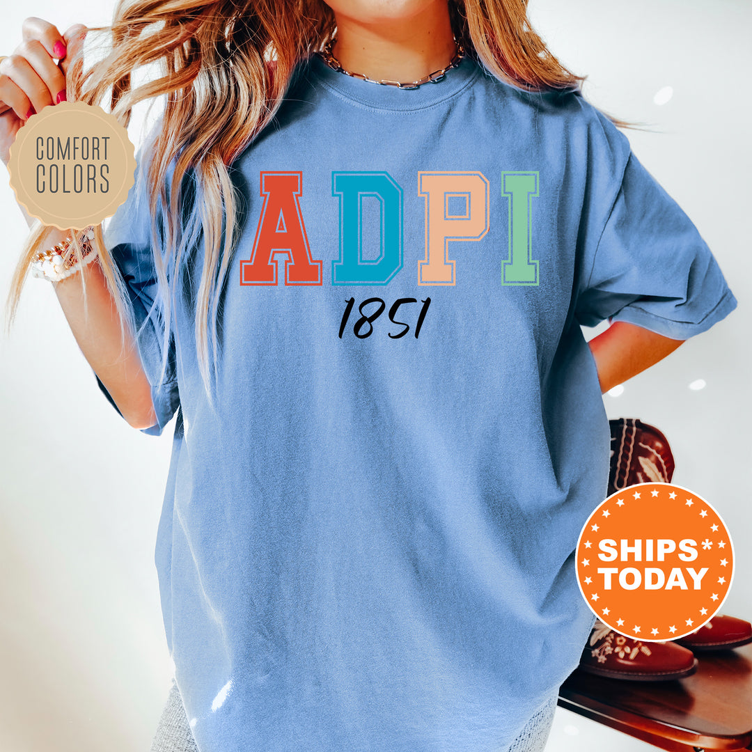 a woman wearing a blue shirt with the word adpi printed on it