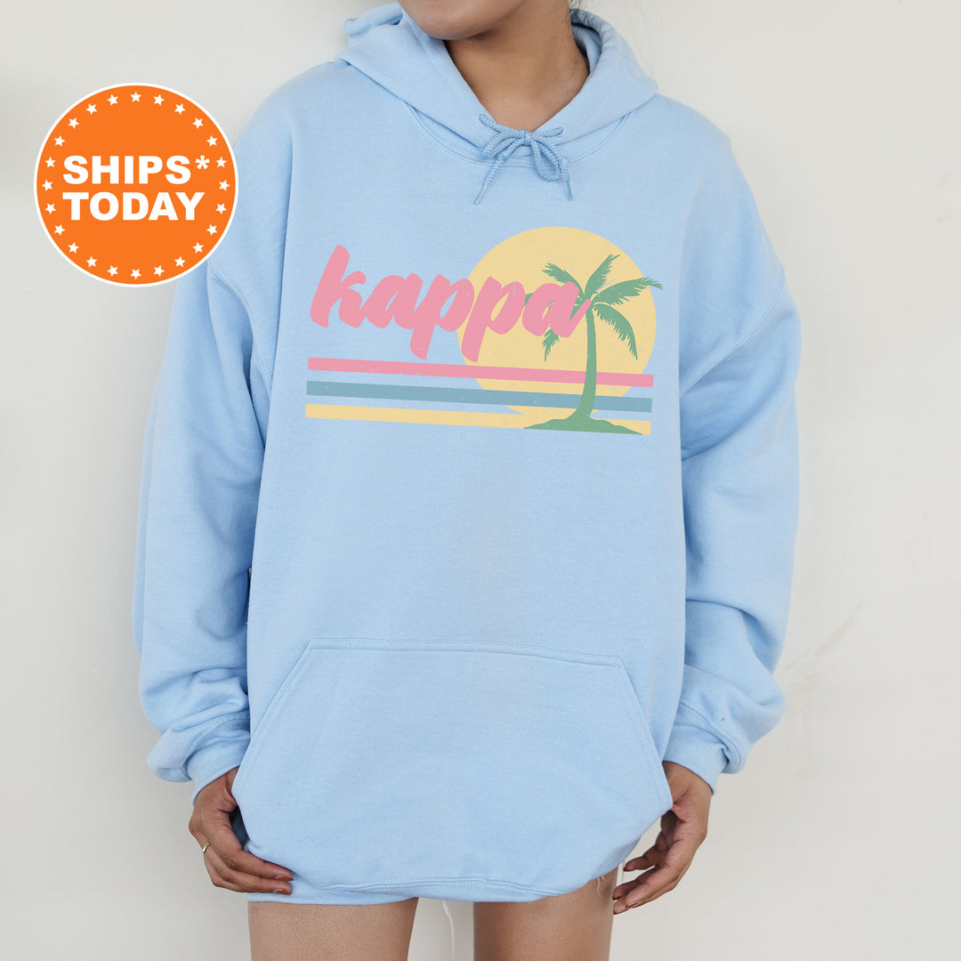 a person wearing a blue hoodie with a palm tree on it