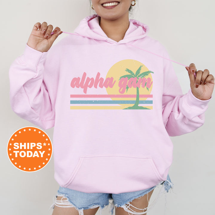 a woman wearing a pink hoodie with a palm tree on it