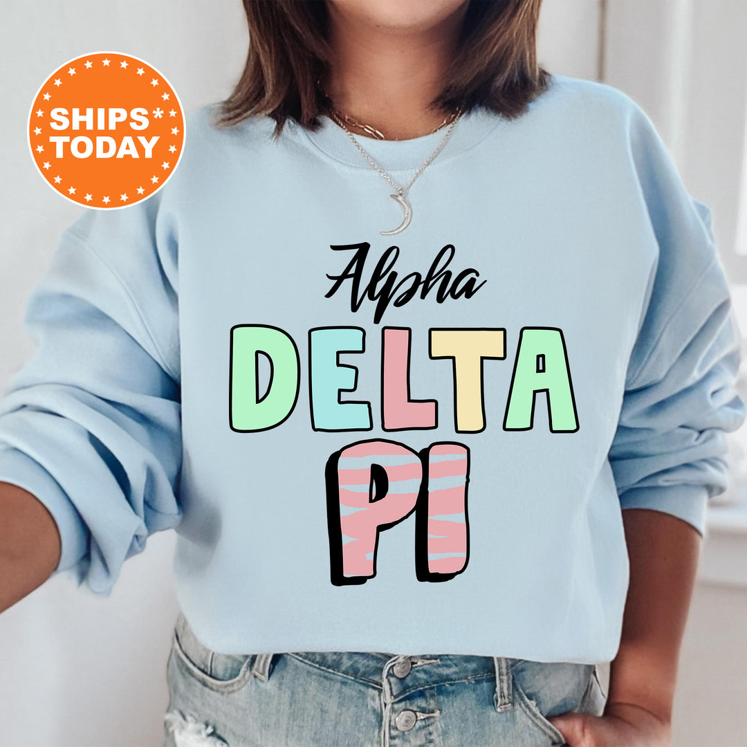 a woman wearing a blue sweatshirt with the words delta pi on it