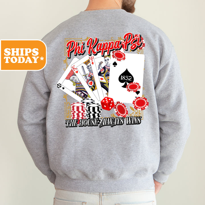 a man wearing a sweatshirt with a picture of playing cards on it