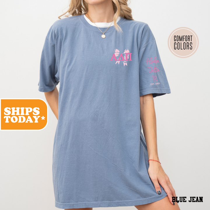 a woman wearing a blue shirt dress with pink flowers on it