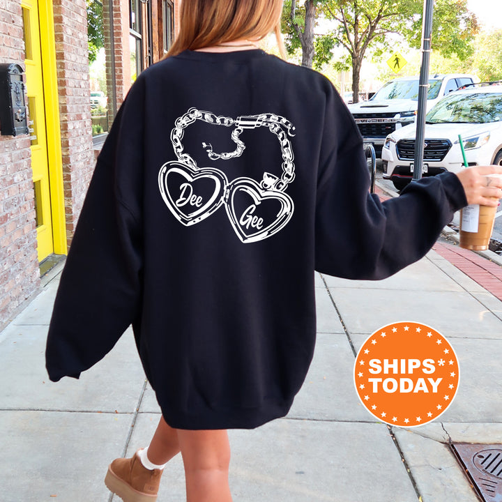 A person wearing a black sweatshirt with a heart-shaped design and text on the back is walking down a sidewalk.