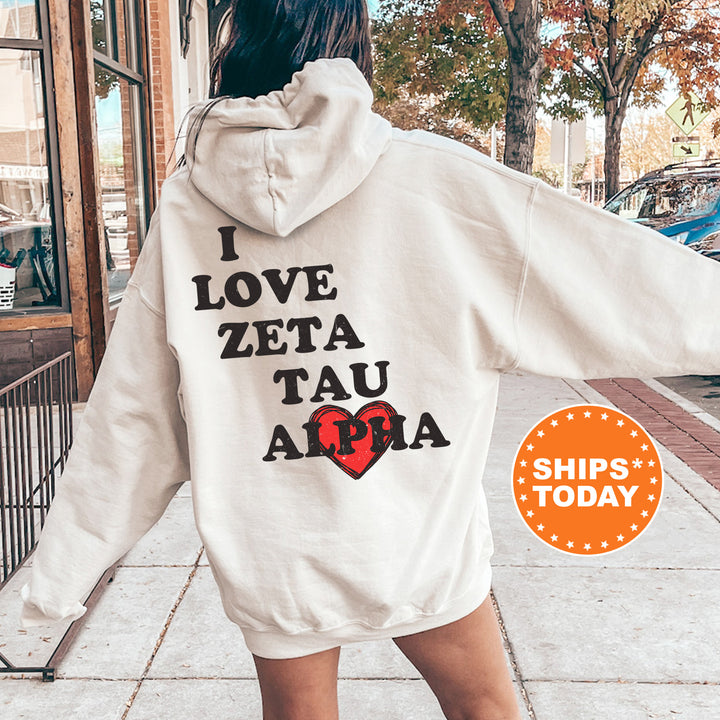 a woman in a white hoodie is walking down the street