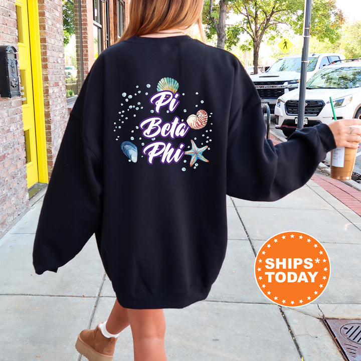 a woman walking down a sidewalk wearing a black sweatshirt