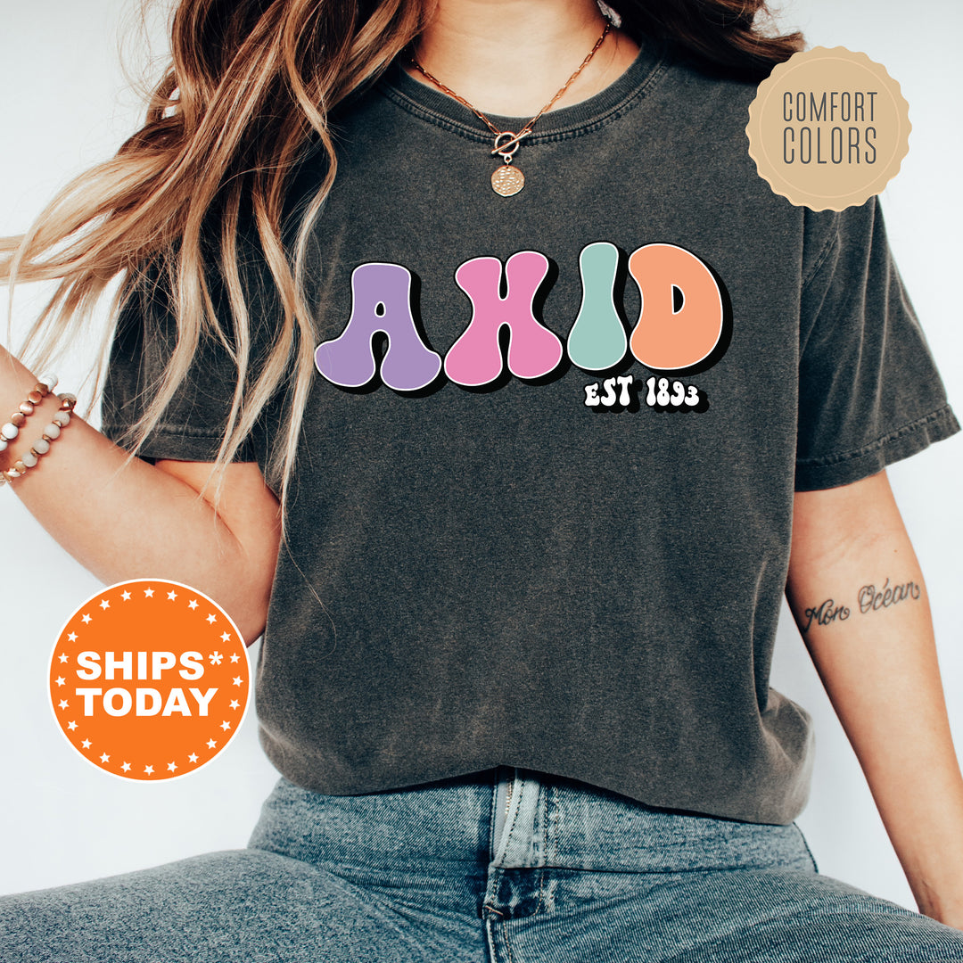 a woman wearing a black shirt with colorful letters on it