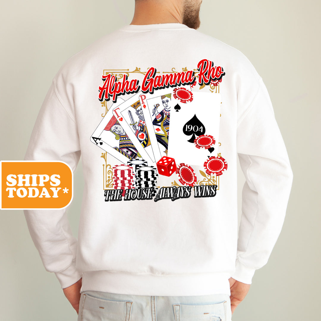 a man wearing a white sweatshirt with a graphic of playing cards