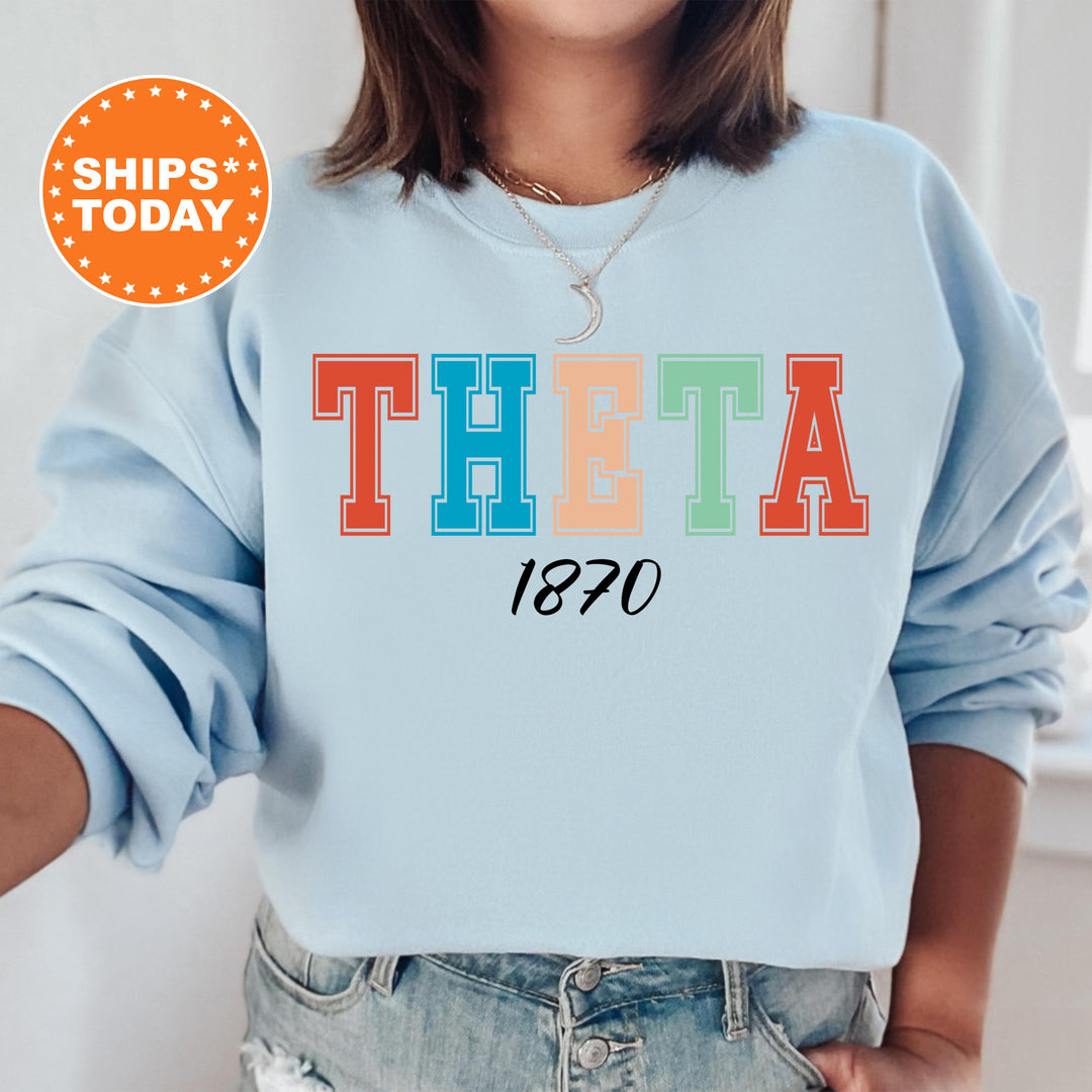 a woman wearing a sweatshirt with the word thea printed on it