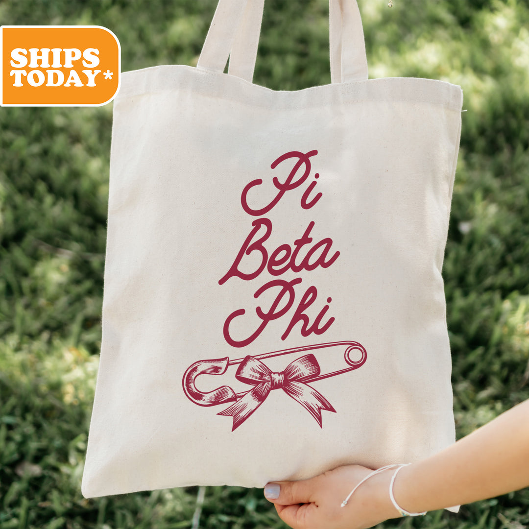a person holding a tote bag that says pi beta phi