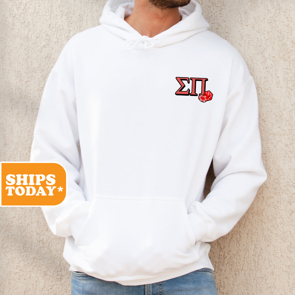 a man standing against a wall wearing a white hoodie