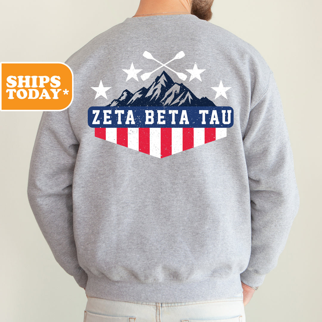 a man wearing a sweatshirt with a mountain and stars on it