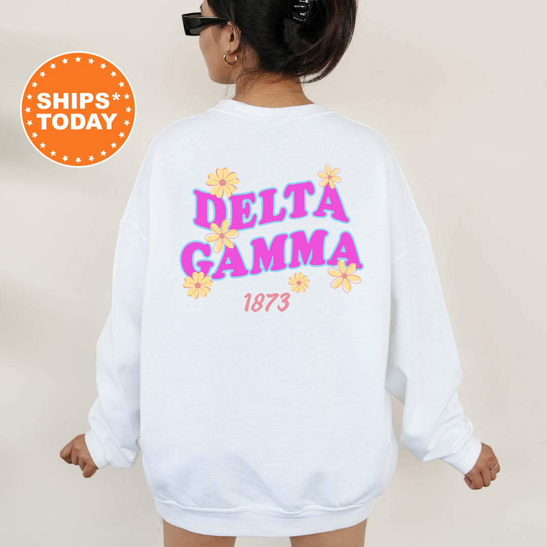 A woman wearing a white sweatshirt with the Delta Gamma sorority's logo and the year 1873 printed on it.